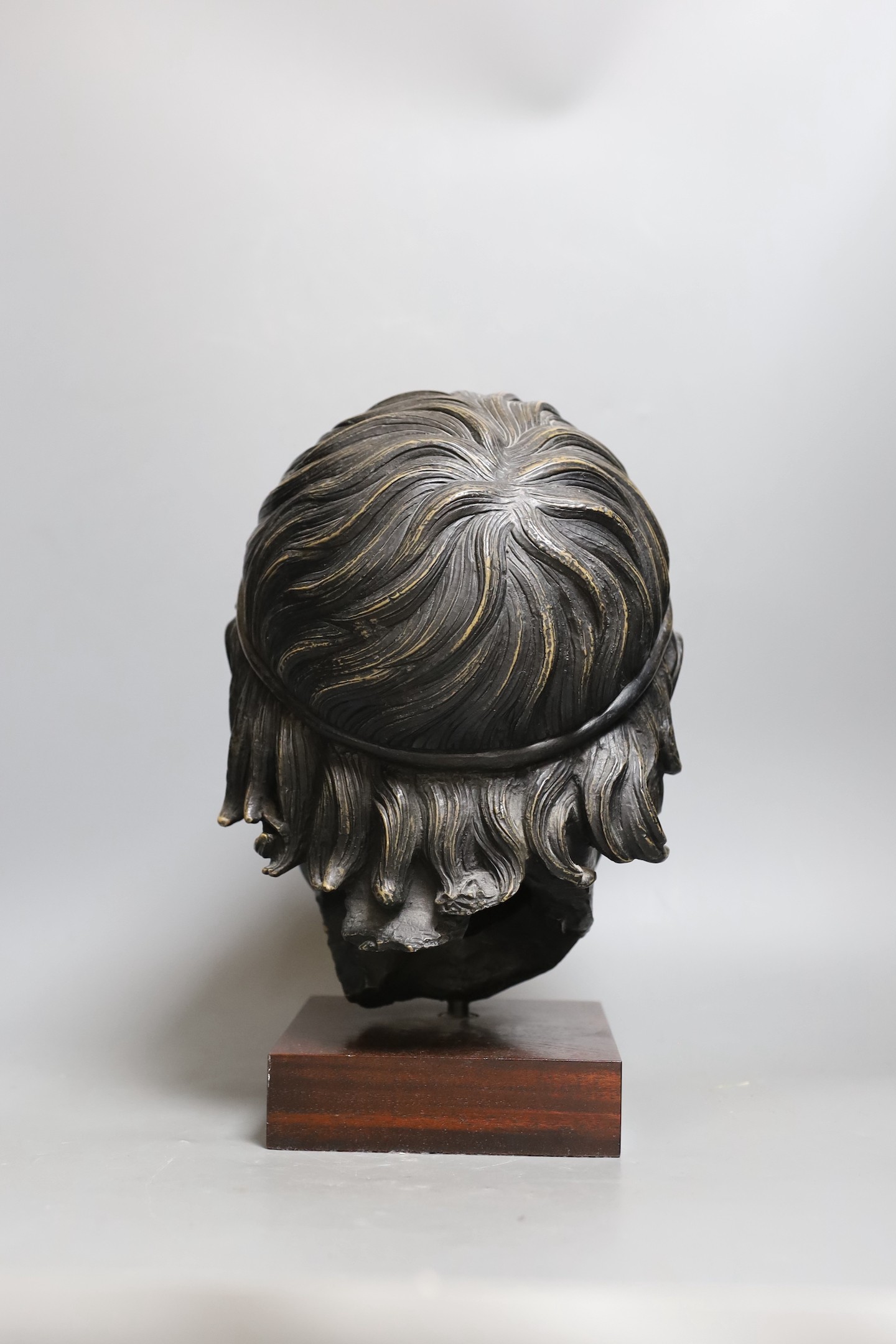 A bronzed composition figure of a classical head. 32cm tall